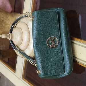 Green leather Michael Kors purse slightly used.